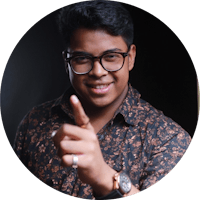 a man in glasses is pointing his finger at the camera